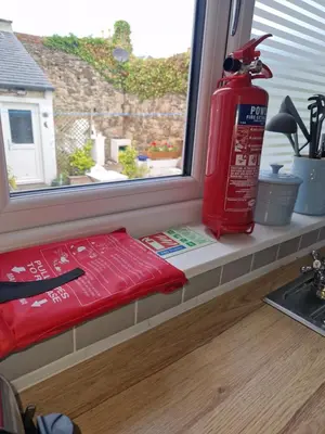 a red fire hydrant sitting on a window sill at Anchors Retreat in Ayr
