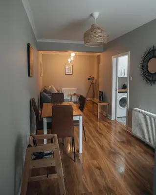 a living room with a table and a dining room at Anchors Retreat in Ayr