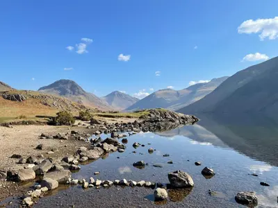 a large body of water with mountains in the background at Tranquil Lake District Village Apartment in St Bees