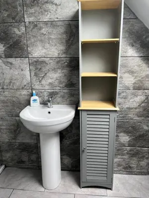 a bathroom with a sink and a shelf and a toilet at Upper Mill Apartment in Newmilns