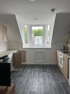 an empty kitchen with a large window in a house at Upper Mill Apartment in Newmilns