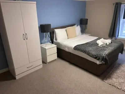 a bedroom with a bed with two towels on it at Abbeygreen Village House in Lesmahagow