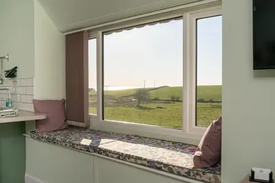 a window seat with a view of a field at The Larroch Byre in Monreith