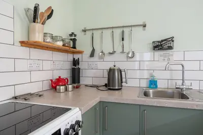 a kitchen with a sink and a counter top at The Larroch Byre in Monreith