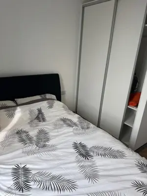 a bedroom with a bed with a black and white blanket at Stylish Flat in City Center in Moffat