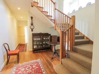 a staircase in a house with a table and a chair at Claymoddie in Newton Stewart