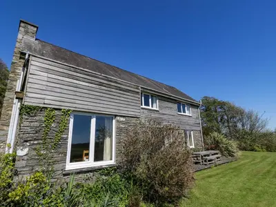an old stone house with windows and a yard at Claymoddie in Newton Stewart