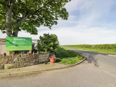 a sign on the side of a road at Manor House Gold 2 Bedroom 20C in Maryport