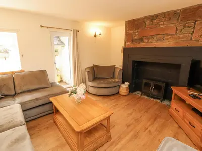 a living room with a couch and a fireplace at Sun House in Maryport