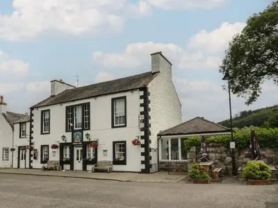 a white building on the side of a street at Fleet Townhouse in Castle Douglas
