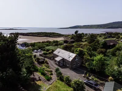 an aerial view of a house and a beach at Owl Cote in Girthon