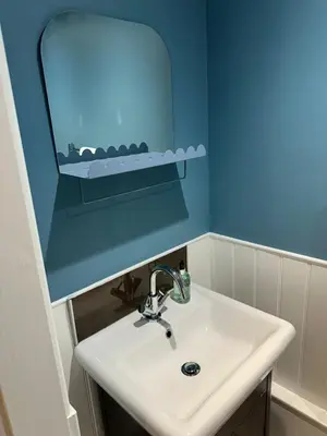 a bathroom with a sink and a mirror at Owl Cote in Girthon