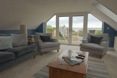 a living room with couches and a coffee table at Owl Cote in Girthon