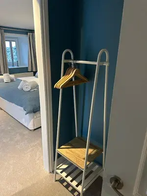 a towel rack in a room with a bedroom at Owl Cote in Girthon
