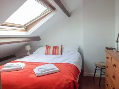 a bedroom with a bed with two towels on it at Emilys View, Ireby budget accommodation with fell views in Ireby