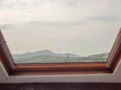 a large window with a view of a bridge at Emilys Apartment, Ireby with fell views, ideal budget holiday for a family in Ireby