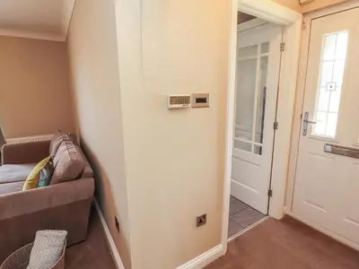 a living room with a couch and a door at 3 Hawk Place in Whitehaven