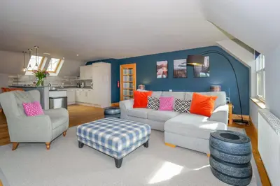 a living room with a couch and two chairs at Hill View at Kenmuir in Dalbeattie