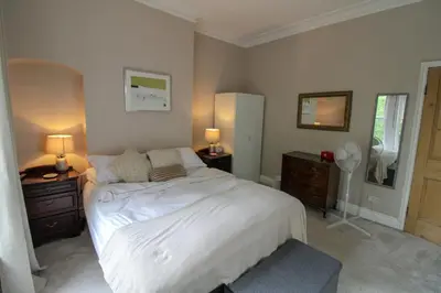 a bedroom with a bed with two night stands and two lamps at Chertsey Mount Townhouse, within 10 minutes walk of Carlisle city centre, shops, pubs & restaurants in Carlisle