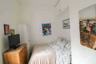 a bedroom with a bed and a television in it at Chertsey Mount Townhouse, within 10 minutes walk of Carlisle city centre, shops, pubs & restaurants in Carlisle