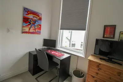 a room with a desk with a television and a deskictericter at Chertsey Mount Townhouse, within 10 minutes walk of Carlisle city centre, shops, pubs & restaurants in Carlisle