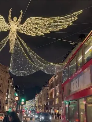 a city street with christmas lights in the air at Apartment in the heart of London in Moffat