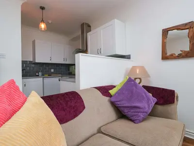 a living room with a couch with colorful pillows at Duncan Square in Whitehaven
