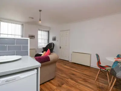 a living room with a couch and a table at Duncan Square in Whitehaven