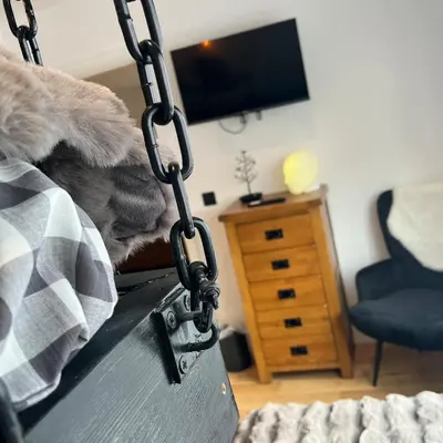 a swing in a living room with a bedroom at The Fishermans Rest in Castle Douglas