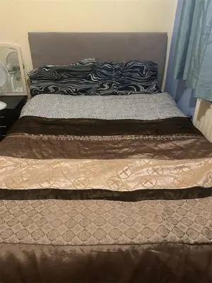 a bed with two pillows on top of it at Home Sweet Home in Moffat