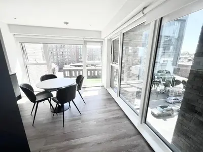a dining room with a table and chairs and large windows at Blucher St in Moffat