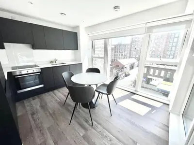 a kitchen with a table and chairs and a large window at Blucher St in Moffat