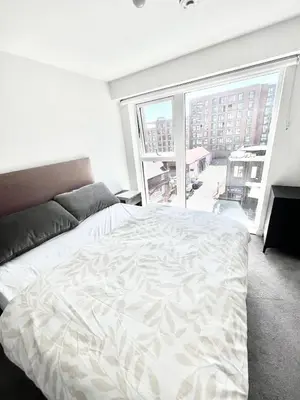 a bedroom with a large bed and a large window at Blucher St in Moffat