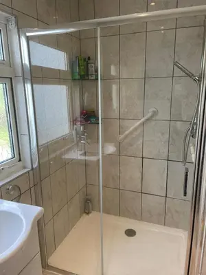 a shower with a glass door in a bathroom at Home in Reading Uni Area in Moffat