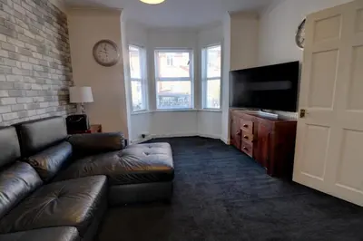 a living room with a couch and a flat screen tv at Home in Reading Uni Area in Moffat