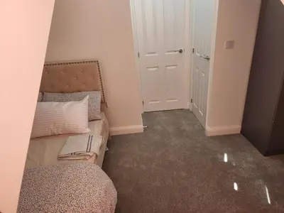 a small room with a couch and a door at Edinburgh Road Nuneaton in Moffat