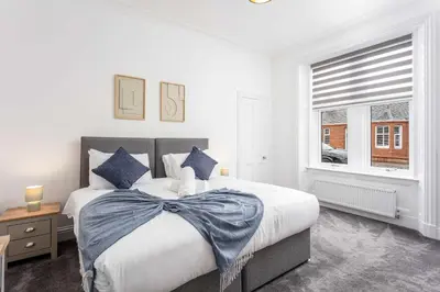 a bedroom with a large bed and a window at No20 Mansfield - Donnini Apartments in Prestwick