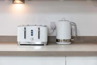 a toaster and coffee maker on a kitchen counter at No20 Mansfield - Donnini Apartments in Prestwick