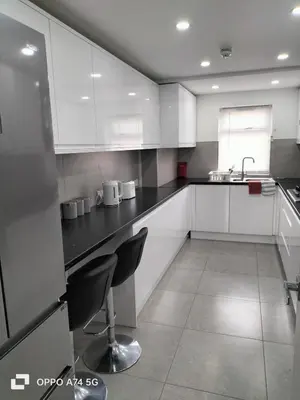 a kitchen with white cabinets and black counter tops at Quiet 5BR Ideal for Groups in Moffat