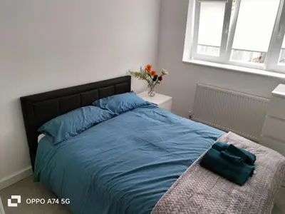 a bedroom with a bed with a blue comforter at Quiet 5BR Ideal for Groups in Moffat