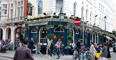 a group of people walking on a busy city street at Smart Artistic studio in shoreditch in Moffat