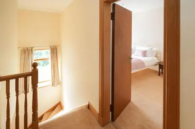 a hallway with a door leading to a bedroom at Shawsmill, outside Hurlford in Hurlford