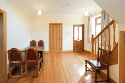 a living room with a wooden table and chairs at Shawsmill, outside Hurlford in Hurlford