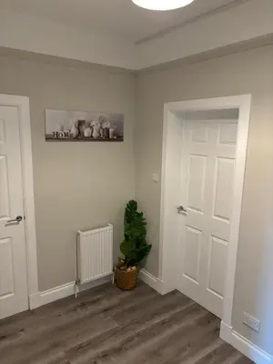 a room with a door and a plant in it at 2 bedroom first floor flat- Bonnie Stays in Troon