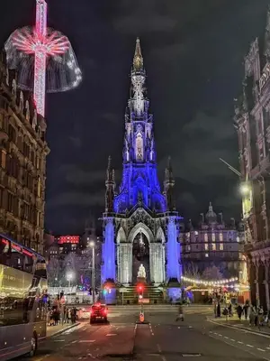 a building is lit up blue at night at Kings suite in Moffat