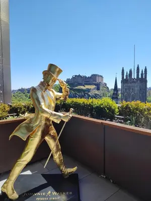 a bronze statue of a man playing a baseball at Kings suite in Moffat