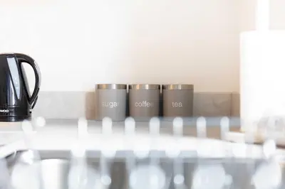 a row of three coffee cups sitting on a table at Albyn Retreat - Donnini Apartments in Prestwick