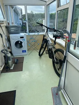 a bike parked in a room with a washing machine at 2 bedroom Lake district cottage in Cockermouth