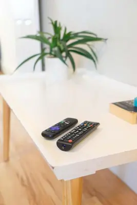 two remote controls sitting on a white table at Saint Nico in Carlisle