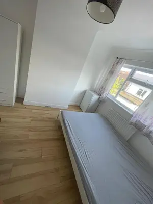 a small bedroom with a bed and a window at Large room with bathroom in Moffat